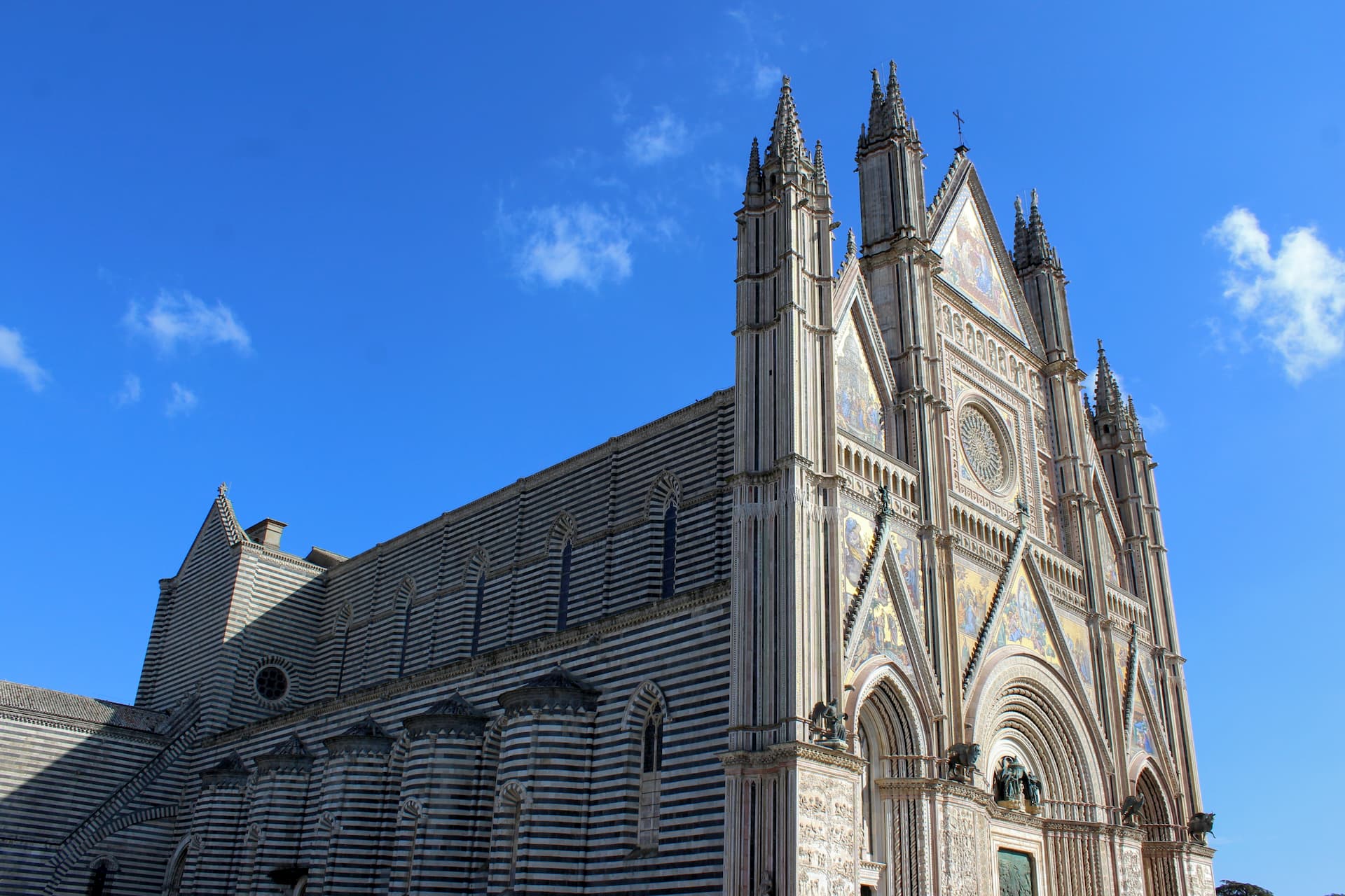 large cathedral with horizontally striped sides and a front facade ornately decorated.