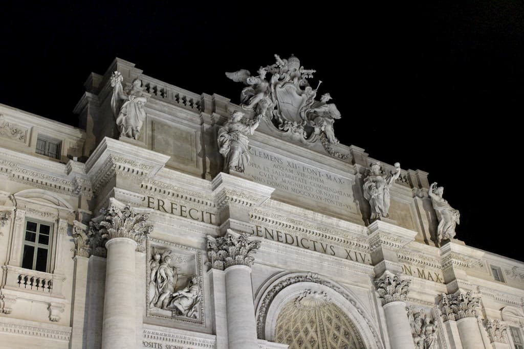 Sculptures and text on building roofline