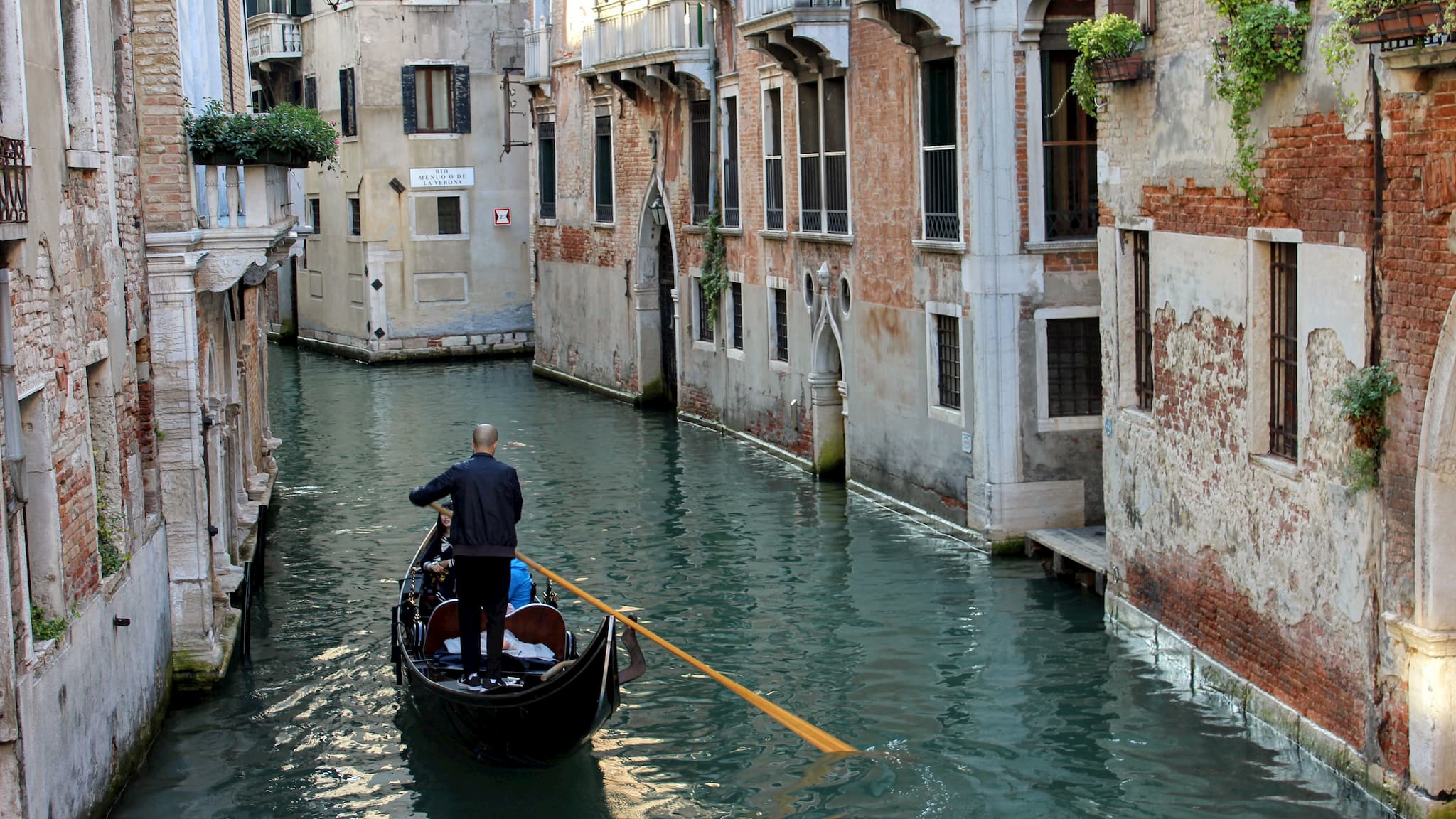 Gondola boat traveling down Venice canal