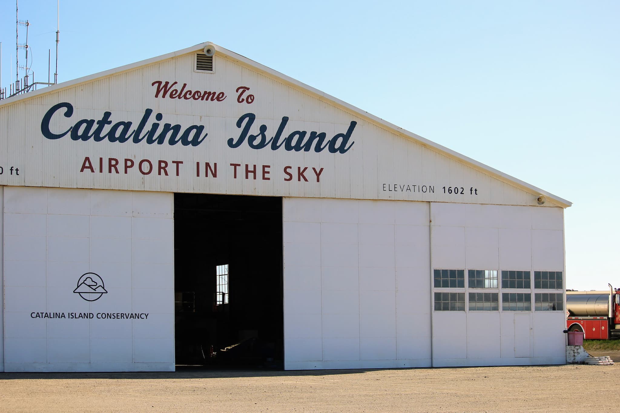 Airport hanger with the text 'Welcome to Catalina Island, Airport in the Sky'.