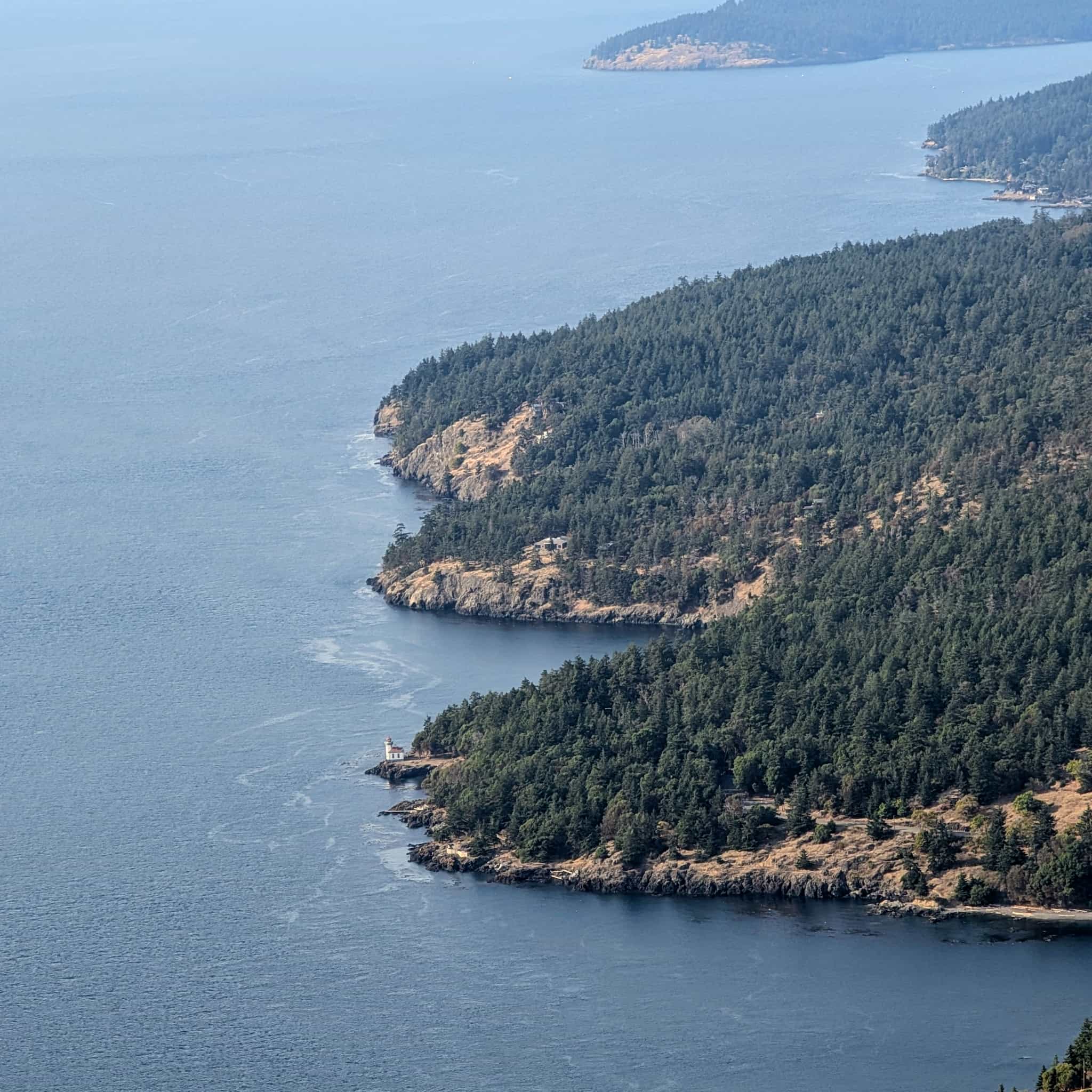 The instrument panel of a small plane with an sky in various shades of orange in the background.