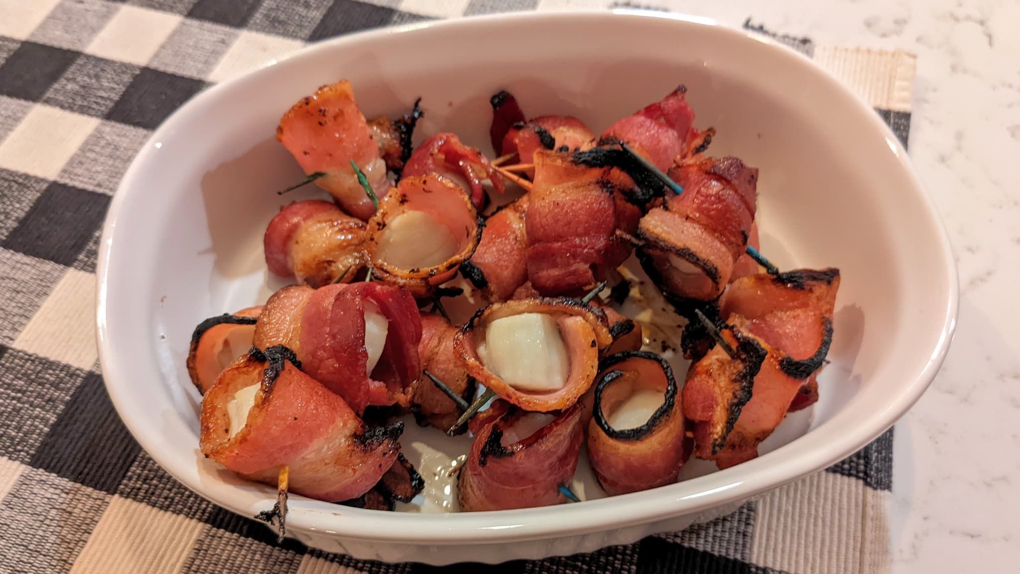 dish of bacon wrapped scallops.