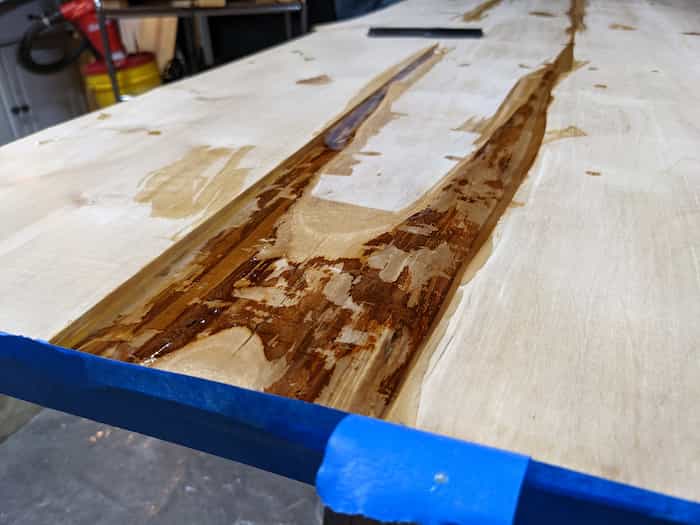 table construction showing rough section of board filled with glassy expoxy mixture