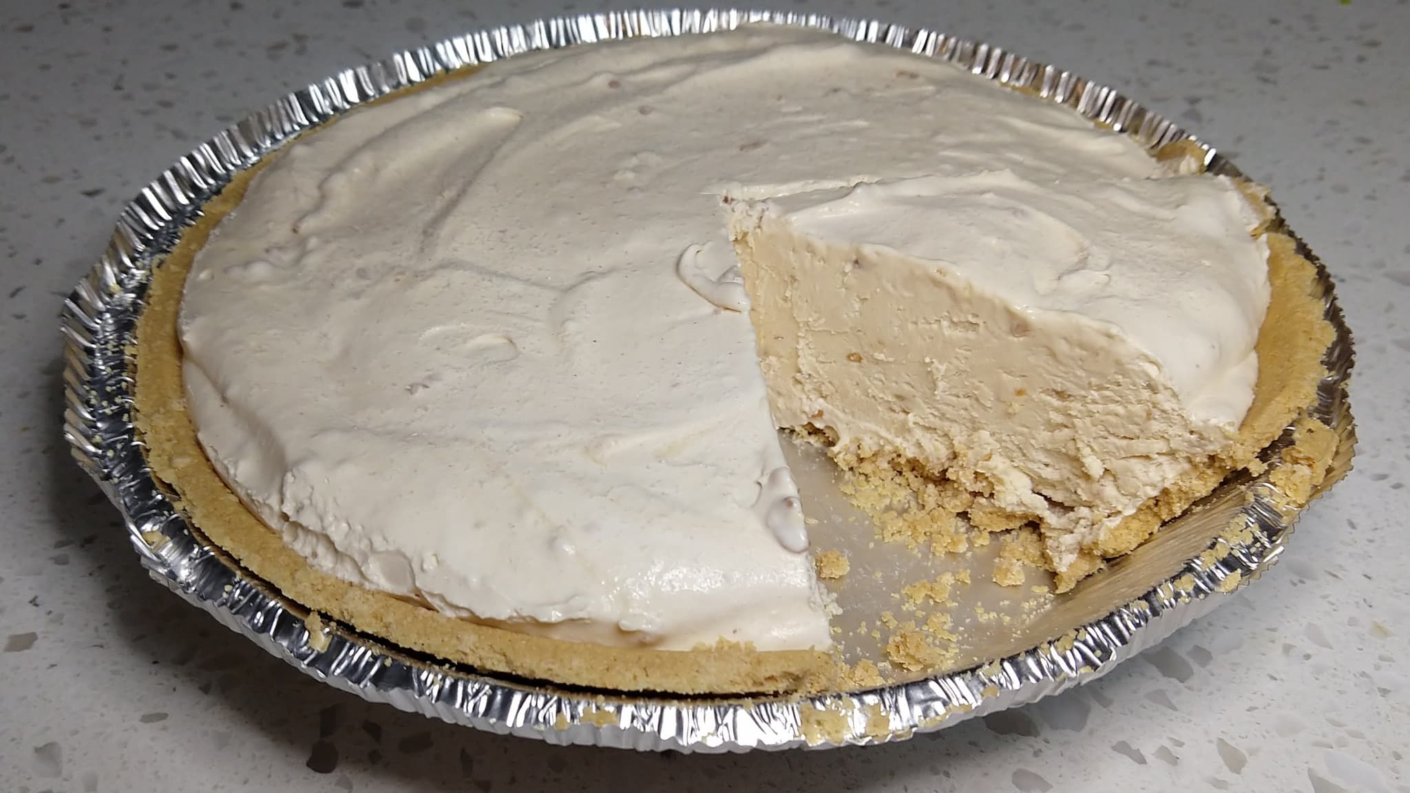 Peanut butter cream pie with slice removed