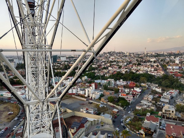 view from ferris wheel ride looking out at buildings 2 to 6 stories tall with trees interspersed between