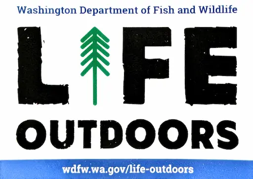 Rectangular sticker from the Washington Department of Fish and Wildlife that says 'Life Outdoors' in blocky text with a tree for the letter I