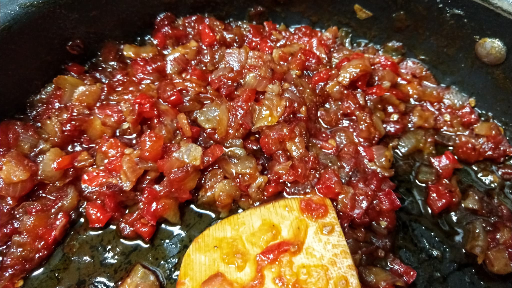 bits of tomato, pepper, and onion in a sauté pan
